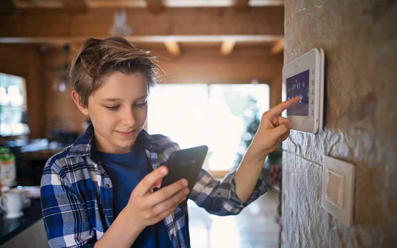 boy using phone to automate home