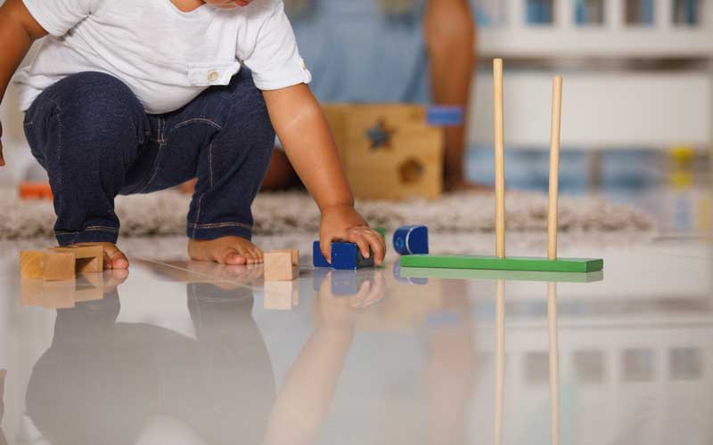child playing with toys on clean floor