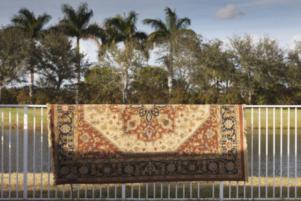 Rug hung on a fence