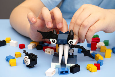 Child building a robot with Legos