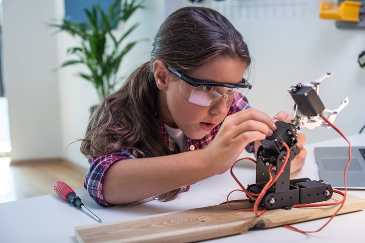 Young girl learning robotics basics